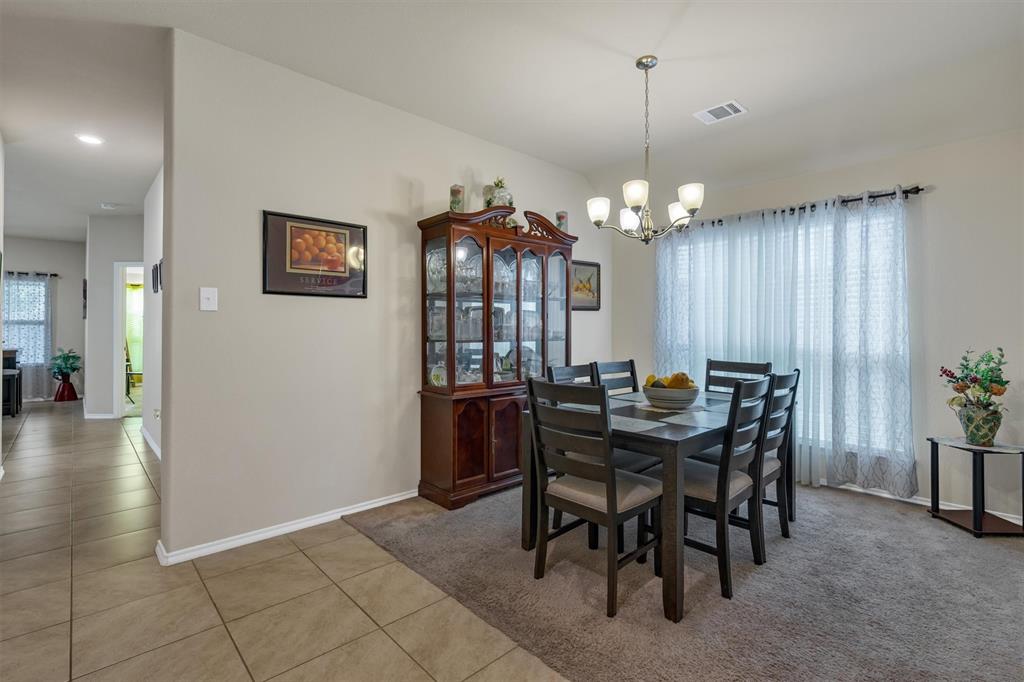520 Rustic Oak Lane McKinney, TX 75072 - Photo 7 of 37 a view of a dining room with furniture and chandelier