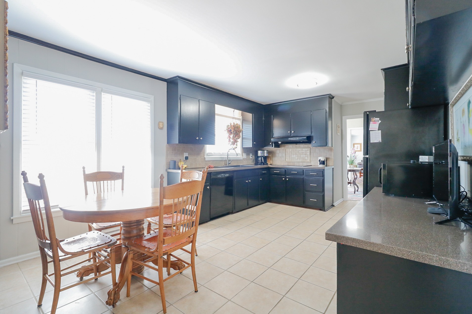 2202 Ruth Street Springfield, TN 37172 - Photo 21 of 51 a kitchen with a table chairs refrigerator and microwave