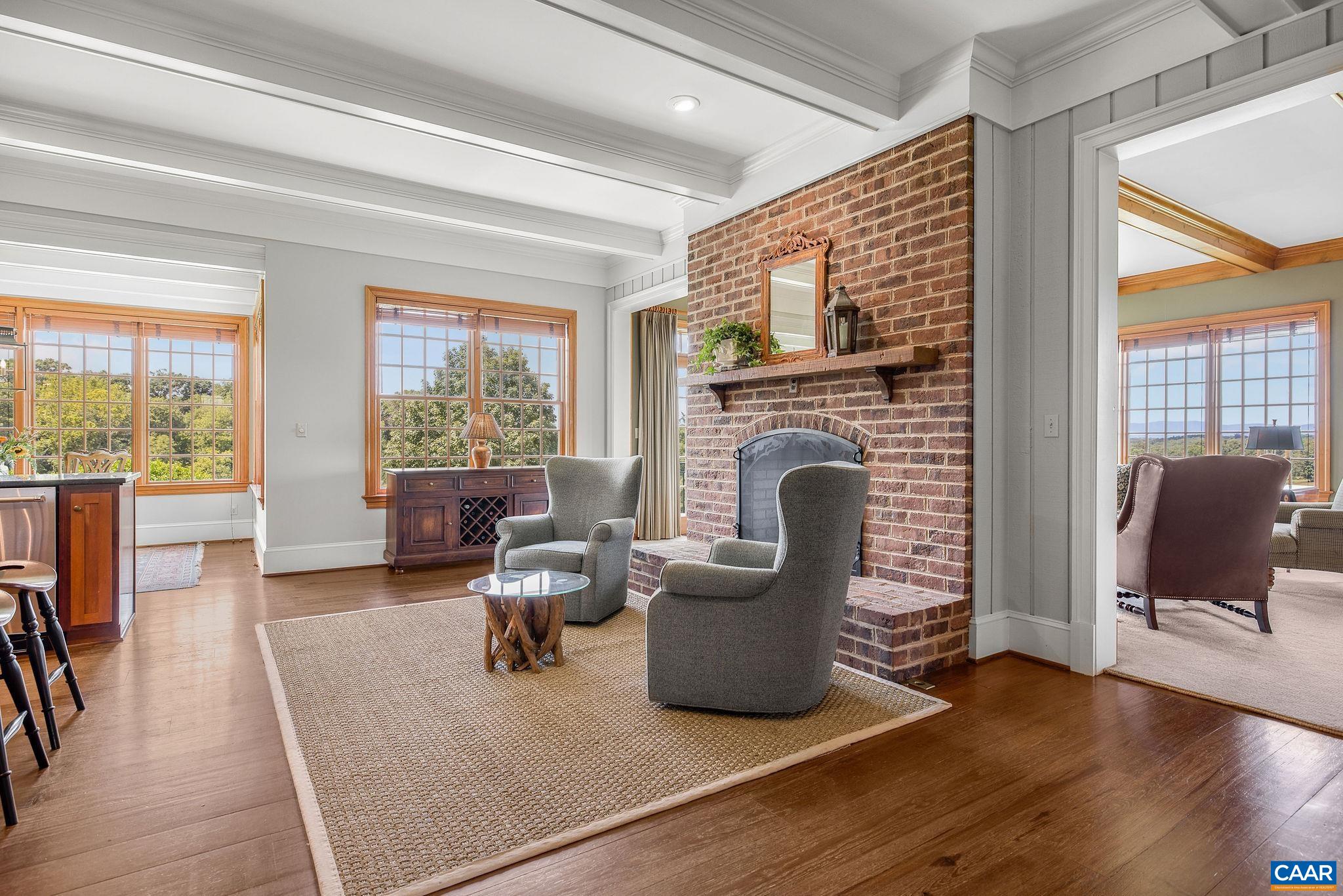 3365 Stony Point Road Charlottesville, VA 22911 - Photo 26 of 75 a living room with furniture a fireplace and a floor to ceiling window