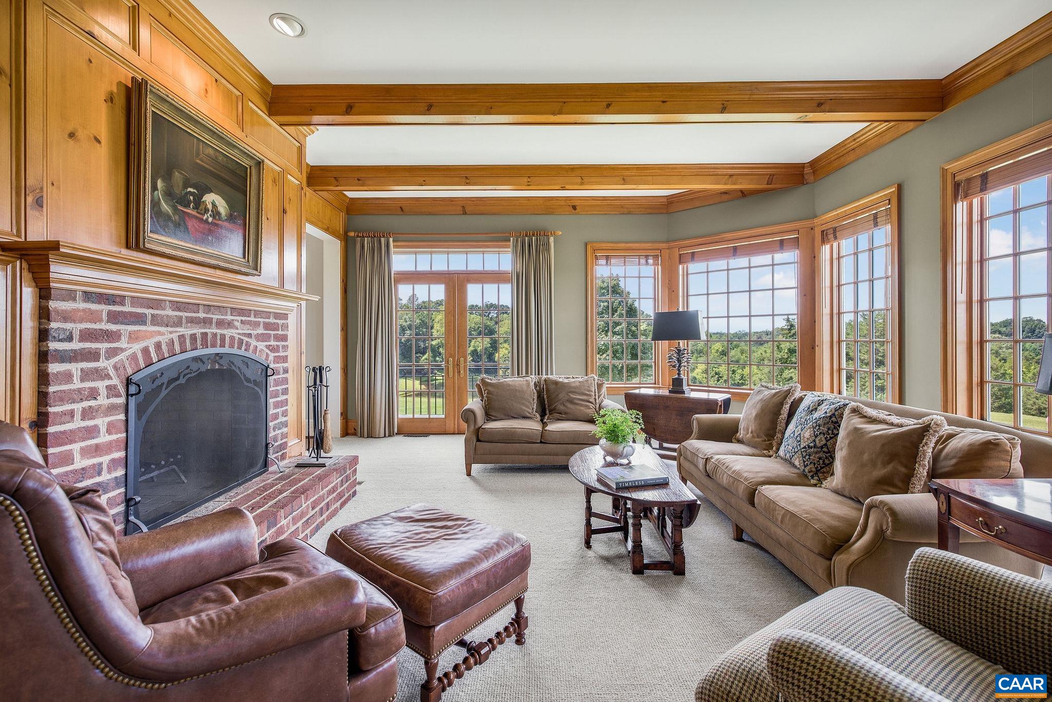 3365 Stony Point Road Charlottesville, VA 22911 - Photo 37 of 75 a living room with furniture large windows and a fireplace