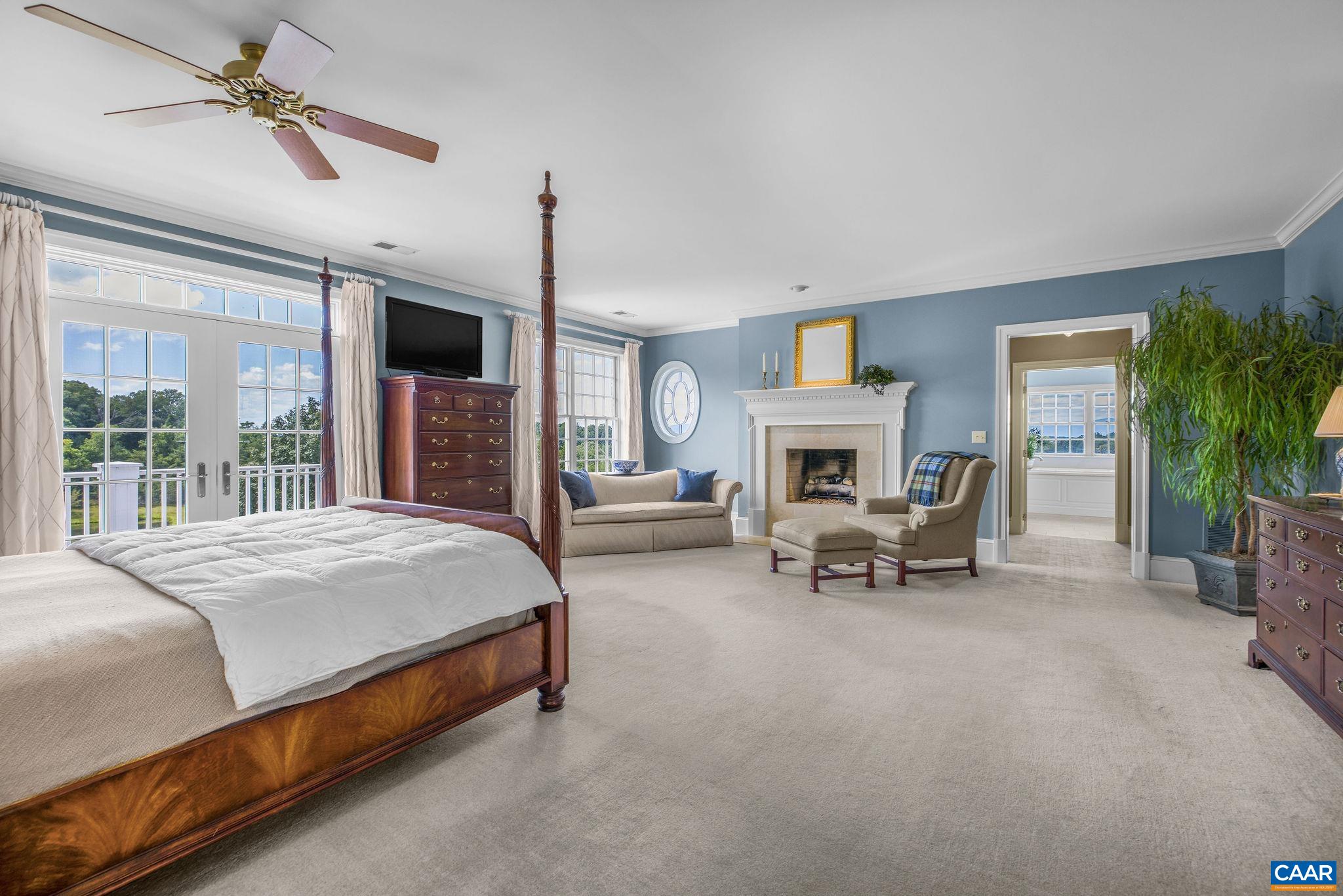 3365 Stony Point Road Charlottesville, VA 22911 - Photo 52 of 75 a spacious bedroom with a bed a fireplace and a large window