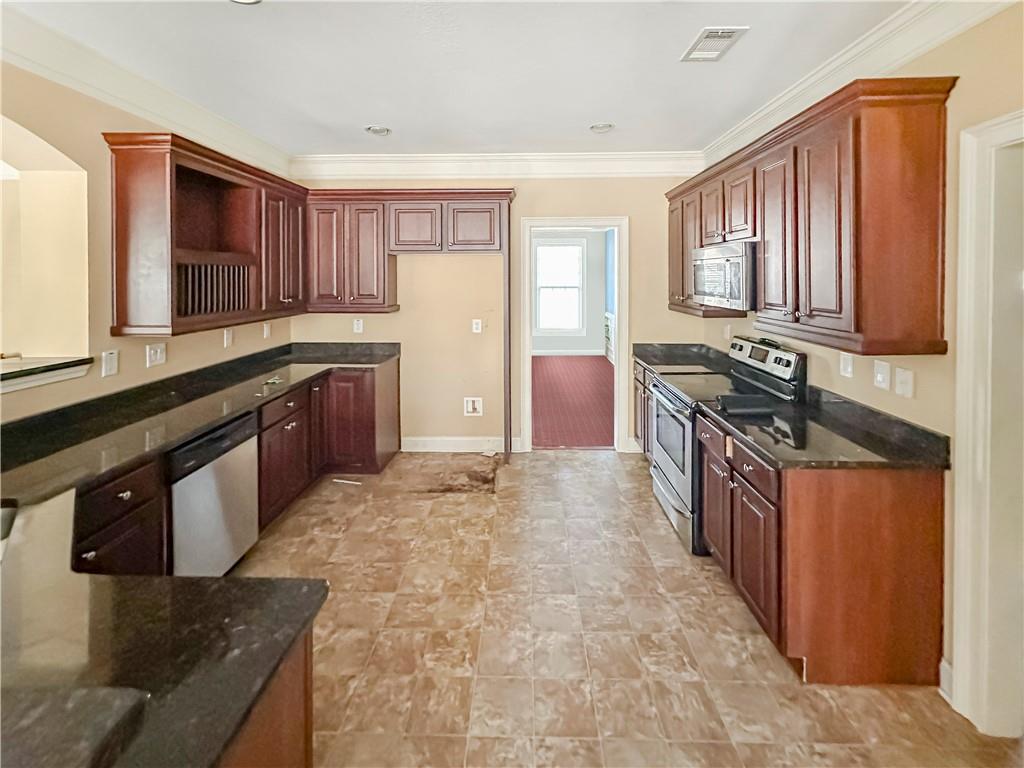 142 Liberty Trace Milner, GA 30257 - Photo 11 of 33 a kitchen with stainless steel appliances granite countertop a stove sink and cabinets