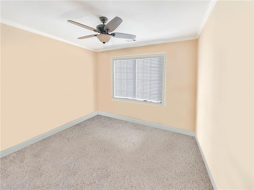 142 Liberty Trace Milner, GA 30257 - Photo 13 of 33 an empty room with a ceiling fan and a window