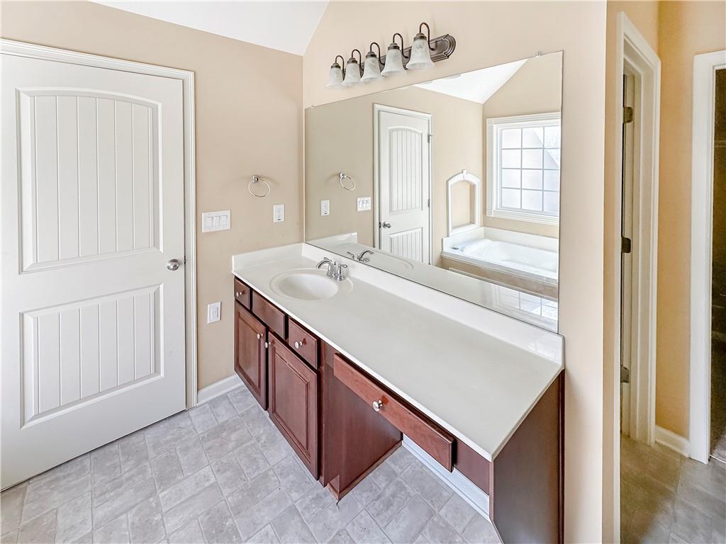 142 Liberty Trace Milner, GA 30257 - Photo 17 of 33 a bathroom with a sink a vanity and a mirror