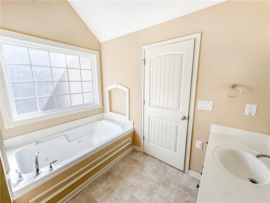 142 Liberty Trace Milner, GA 30257 - Photo 19 of 33 a spacious bedroom with a bed and a window