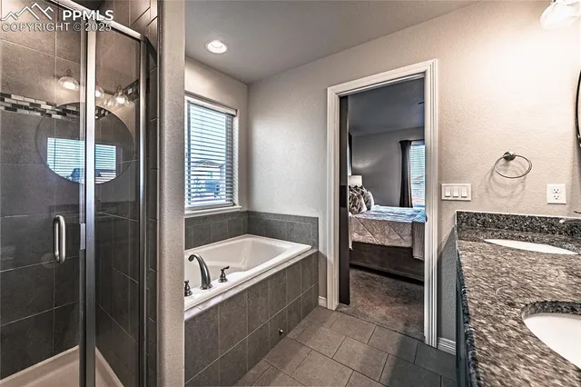 a bathroom with a tub sink and mirror