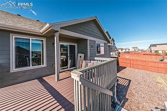 a view of a house with wooden deck