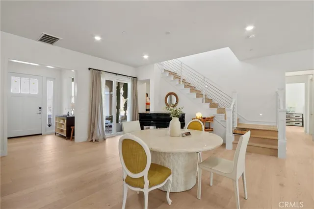 a dining room with furniture and wooden floor