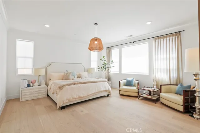 a bedroom with a bed a window and a flat screen television