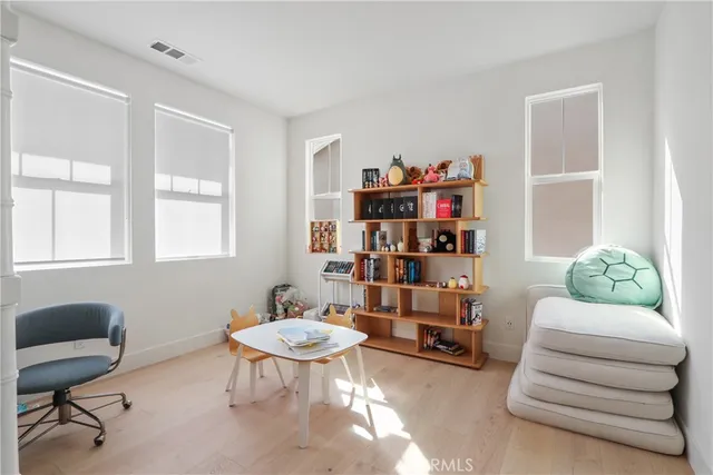 a bathroom with a double vanity sink a toilet and a mirror