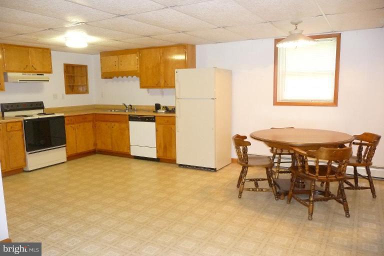 1130 Cox Road Huntingtown, MD 20639 - Photo 25 of 30 a kitchen with stainless steel appliances a stove a sink refrigerator and a table