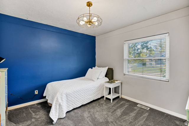 892 East 400 South Smithfield, UT 84335 - Photo 25 of 44 Bedroom featuring suspended lighting and dark carpet