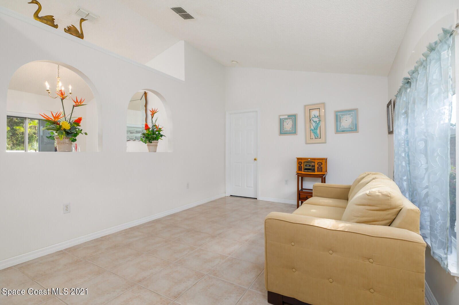 773 Furth Road Northwest Palm Bay, FL 32907 - Photo 15 of 29 a living room with furniture and flowers
