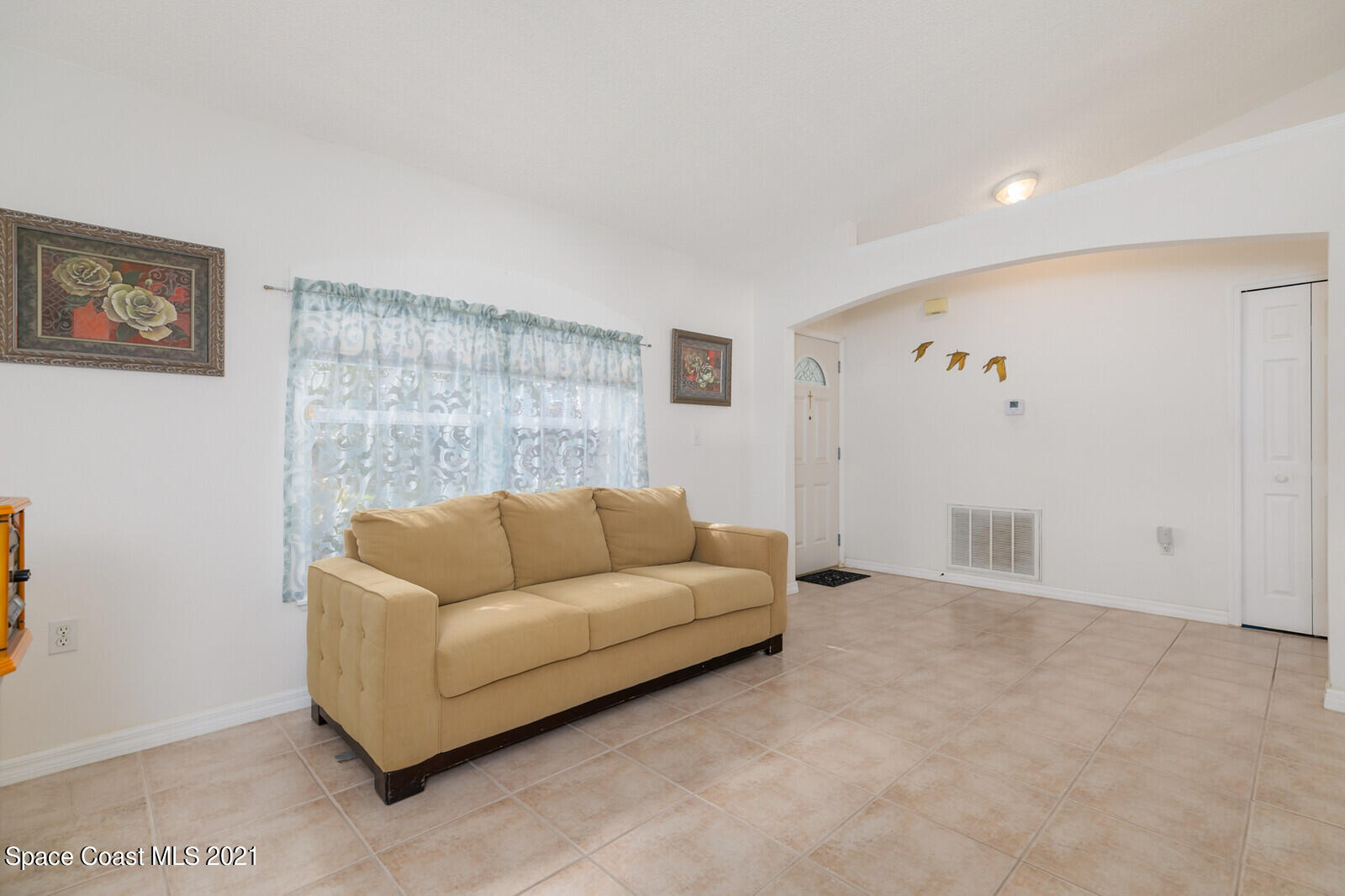 773 Furth Road Northwest Palm Bay, FL 32907 - Photo 16 of 29 a living room with furniture and a wall painting