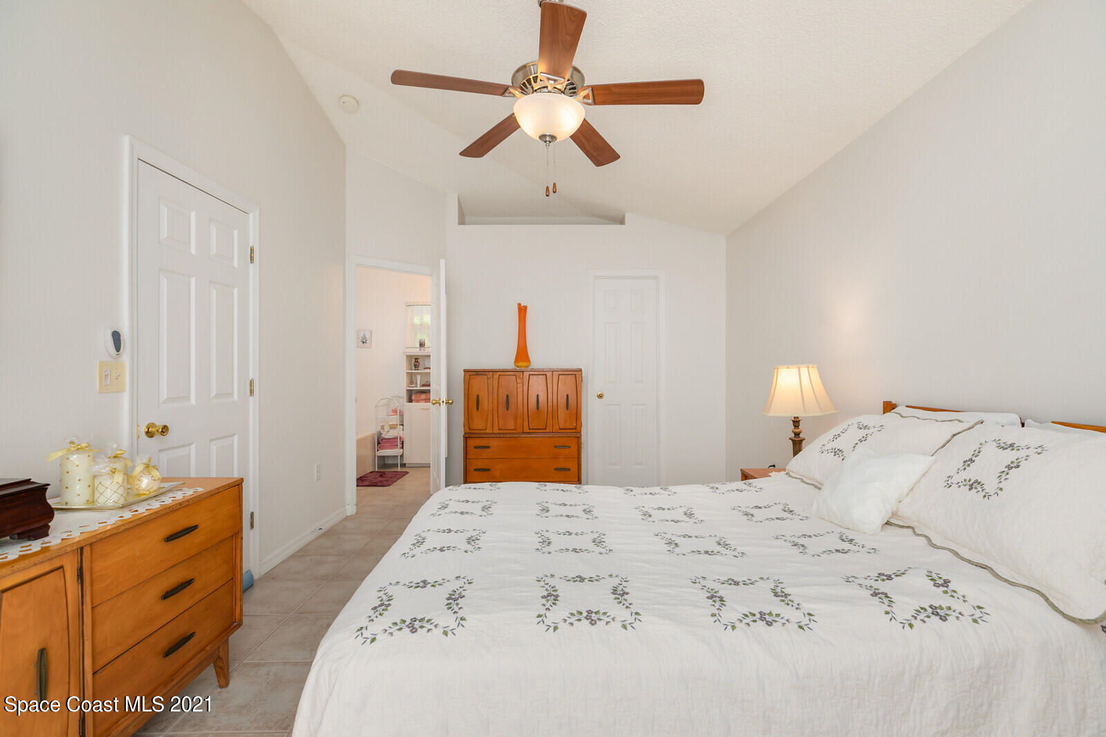 773 Furth Road Northwest Palm Bay, FL 32907 - Photo 18 of 29 a bedroom with a bed and a chandelier