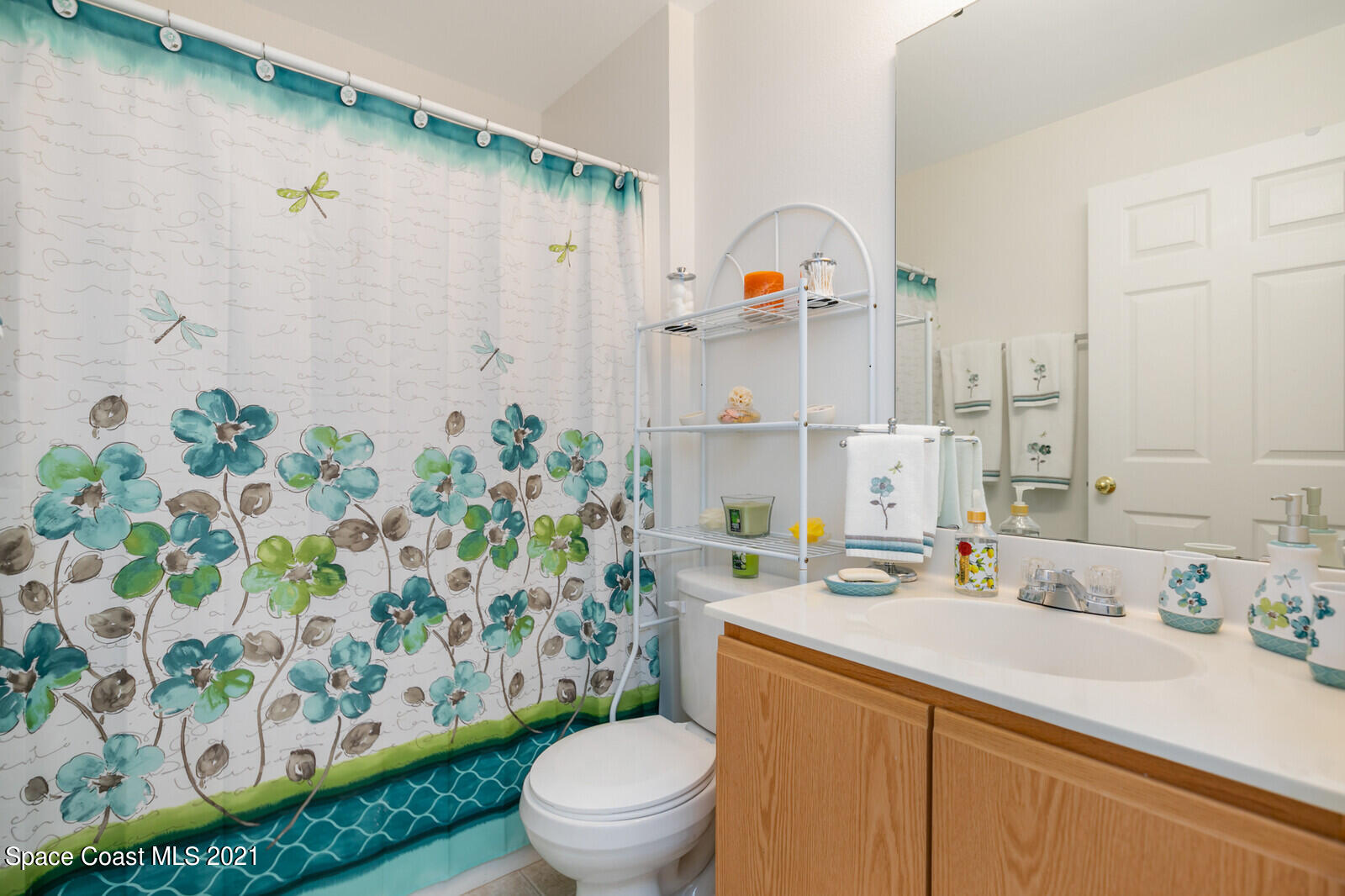 773 Furth Road Northwest Palm Bay, FL 32907 - Photo 23 of 29 a bathroom with a sink a toilet and shower curtain