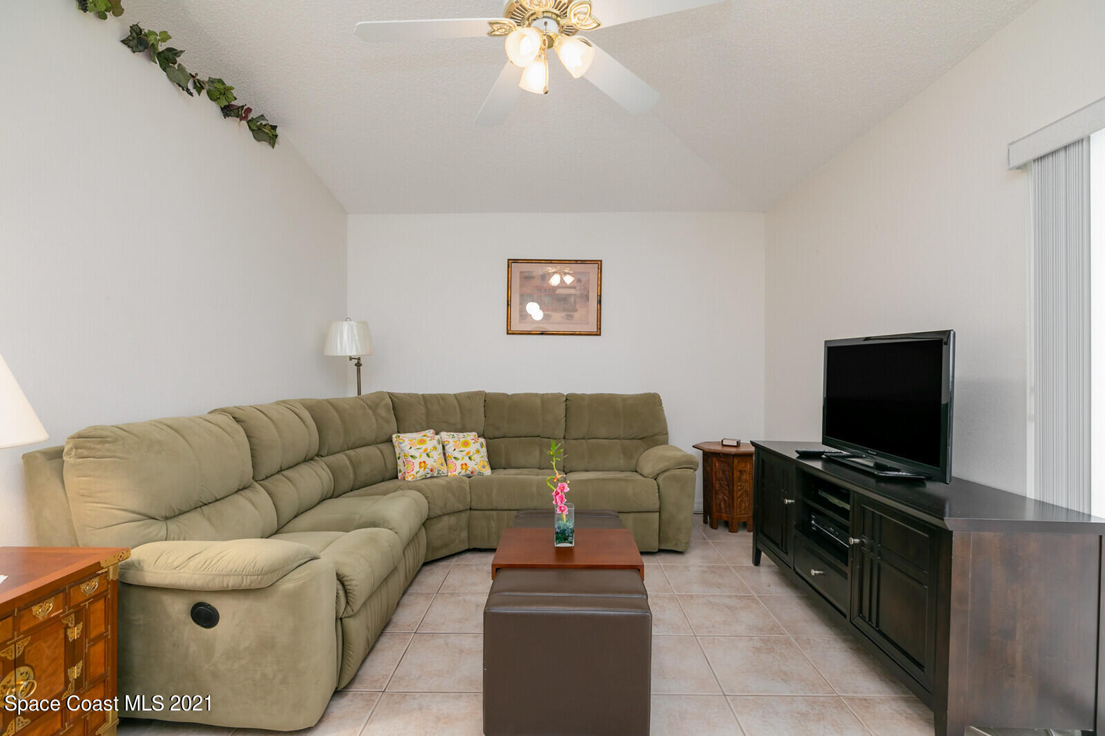 773 Furth Road Northwest Palm Bay, FL 32907 - Photo 6 of 29 a living room with furniture and a flat screen tv