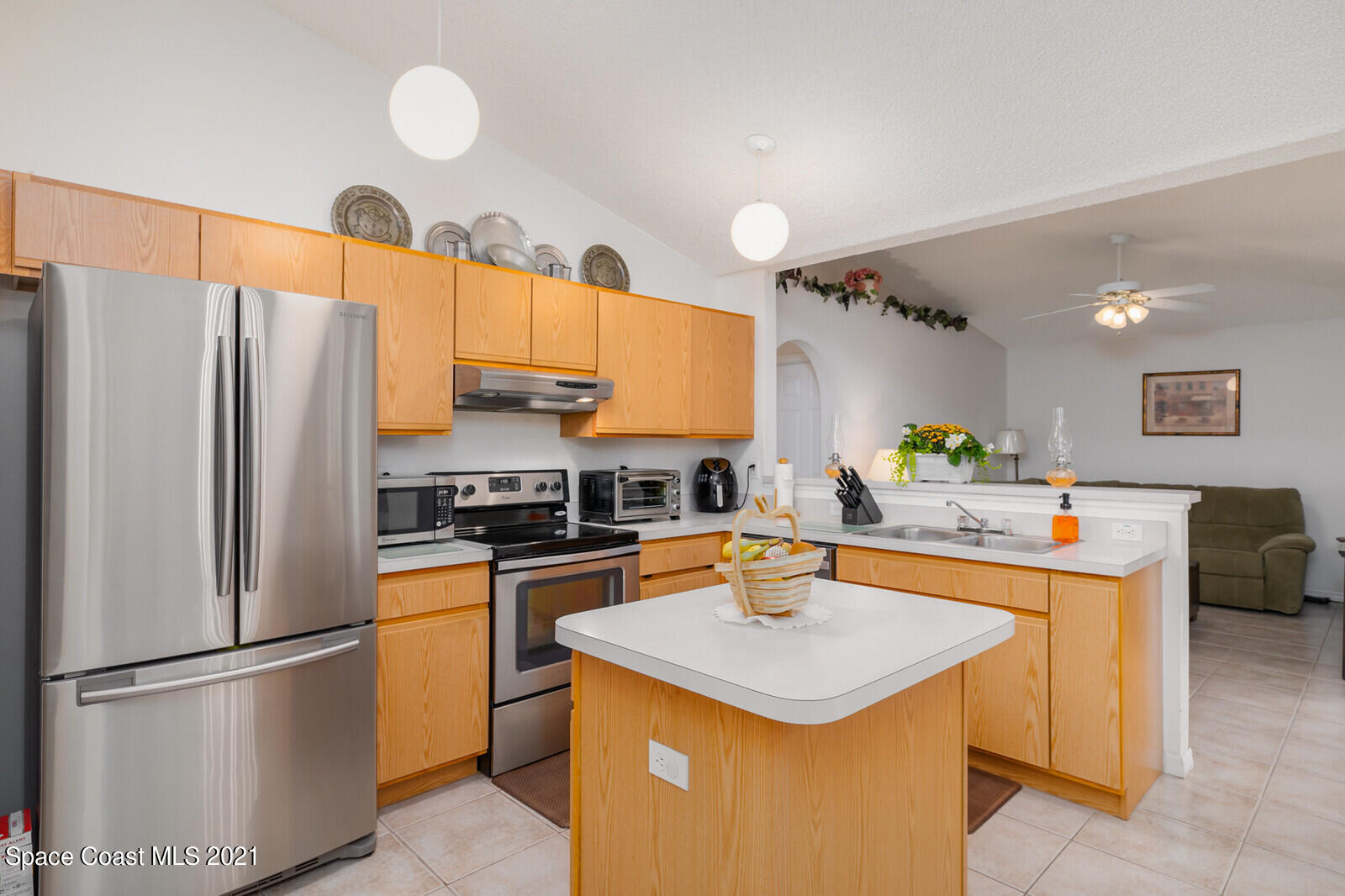 773 Furth Road Northwest Palm Bay, FL 32907 - Photo 8 of 29 a kitchen with stainless steel appliances a refrigerator a sink a stove a dining table and chairs