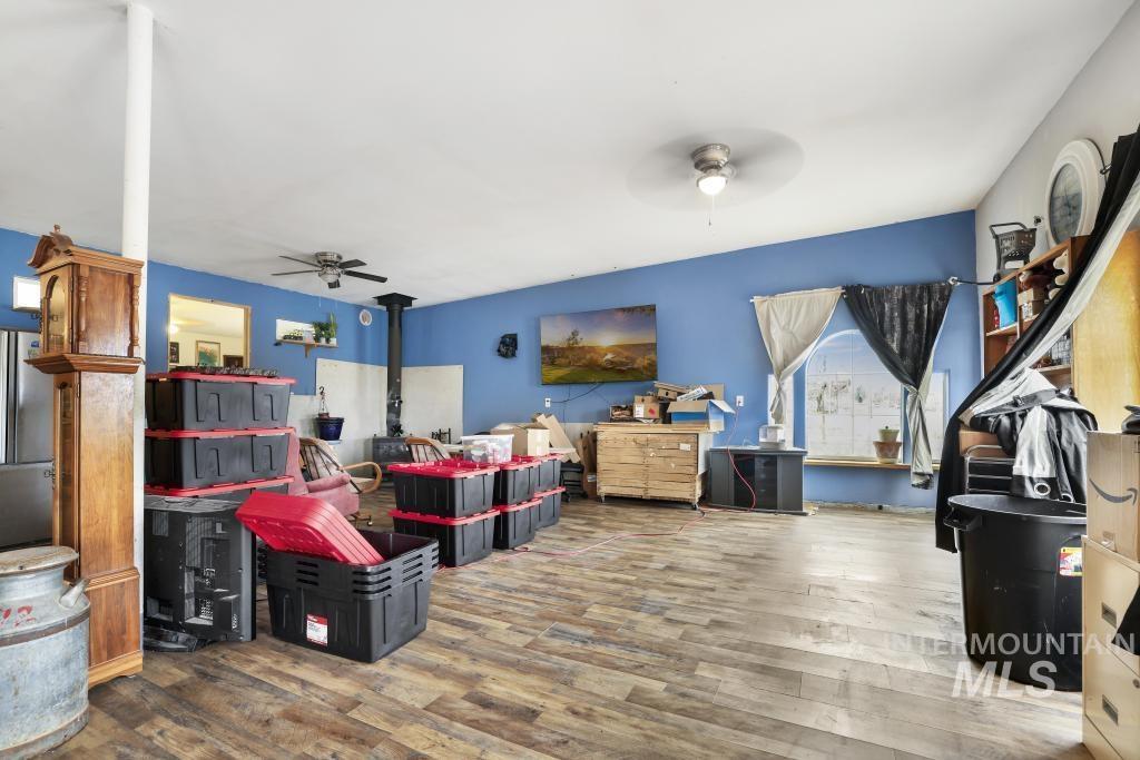315 Wilson Street Eden, ID 83325 - Photo 13 of 30 Living area with ceiling fan, wood finished floors, and a wood stove