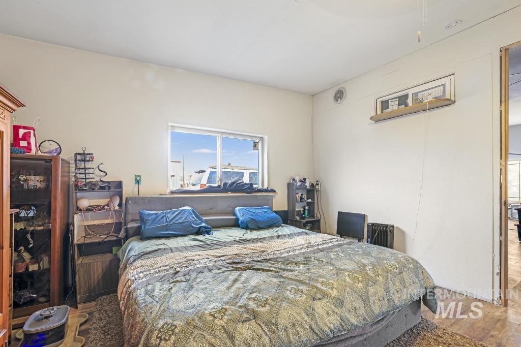 315 Wilson Street Eden, ID 83325 - Photo 17 of 30 Bedroom featuring wood finished floors and radiator