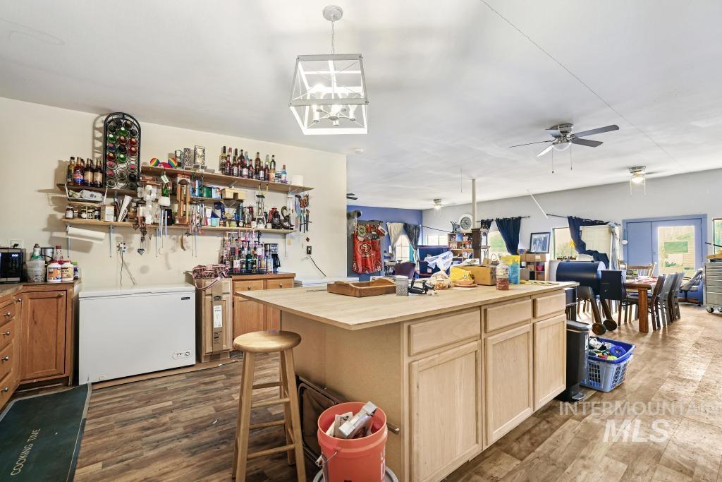 315 Wilson Street Eden, ID 83325 - Photo 30 of 30 Kitchen featuring dark wood-type flooring, light wood finish cabinets, open floor plan, pendant lighting, and ceiling fan