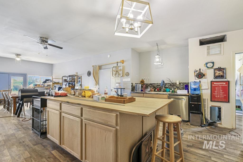 315 Wilson Street Eden, ID 83325 - Photo 5 of 30 Kitchen featuring light wood finish cabinetry, dark wood-style floors, and dishwasher