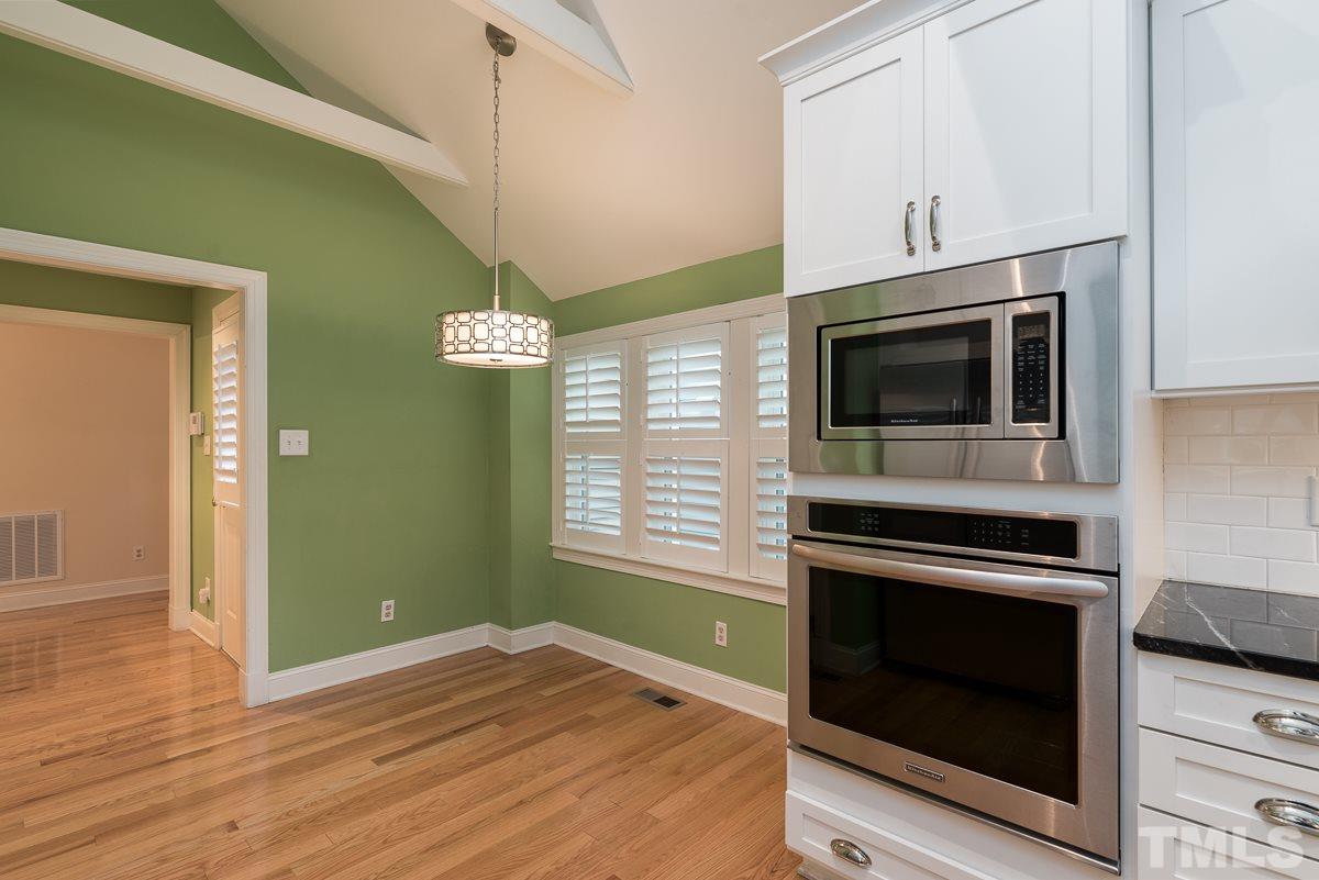 5949 Sentinel Drive Raleigh, NC 27609 - Photo 8 of 25 a kitchen with granite countertop wooden cabinets stainless steel appliances and a counter space