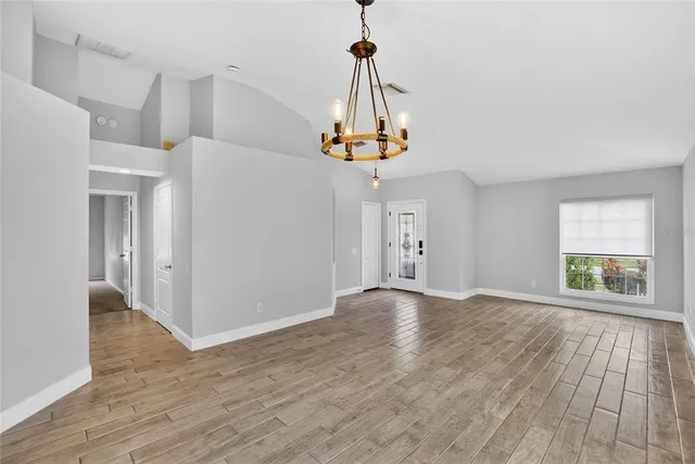 a kitchen with granite countertop a refrigerator stove top oven and sink