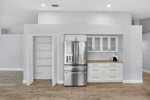 a view of empty room with wooden floor and window