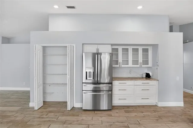 a view of empty room with wooden floor and window