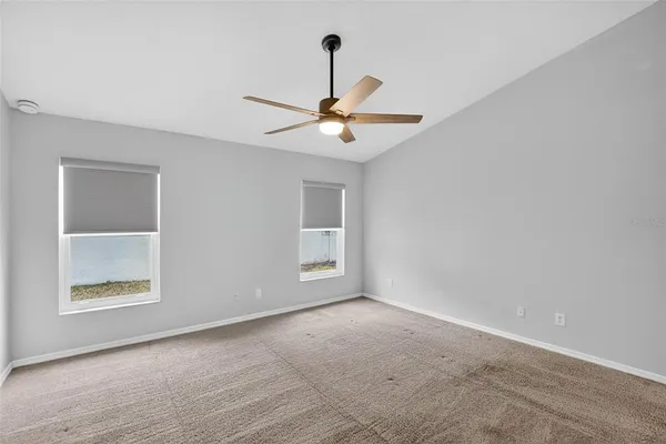 a view of a hallway with wooden floor and closet