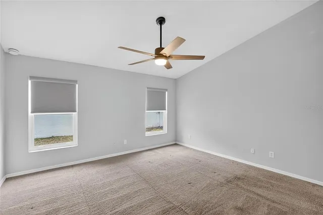 a view of a hallway with wooden floor and closet