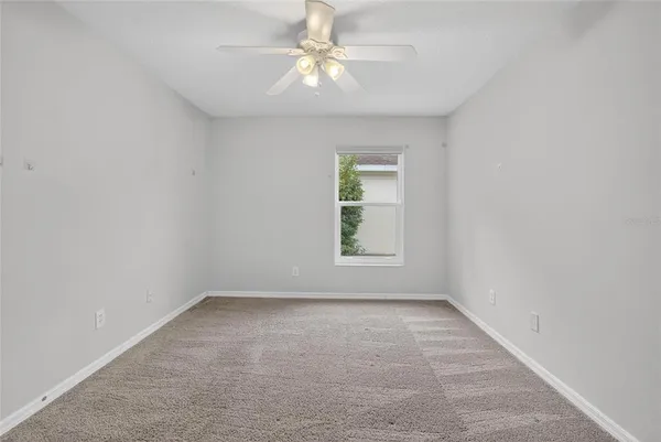 a view of a room with a wooden floor and fence