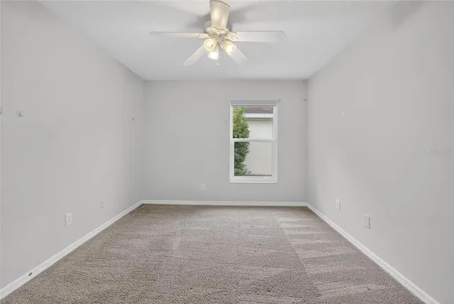 a view of a room with a wooden floor and fence