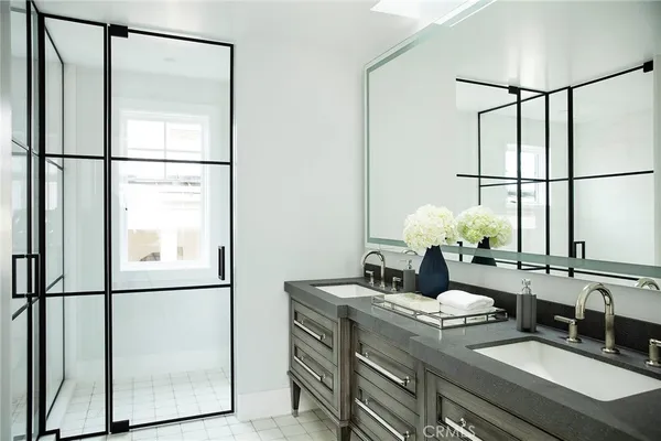 a bathroom with a granite countertop sink mirror and a shower