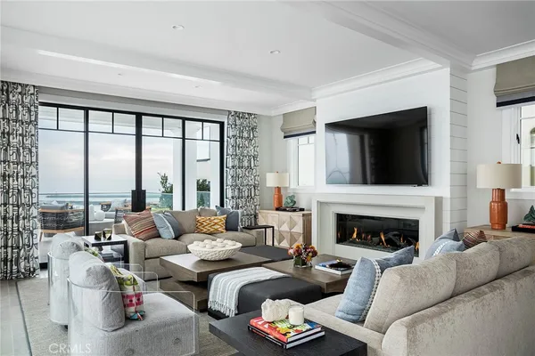 a living room with furniture large window and a fireplace