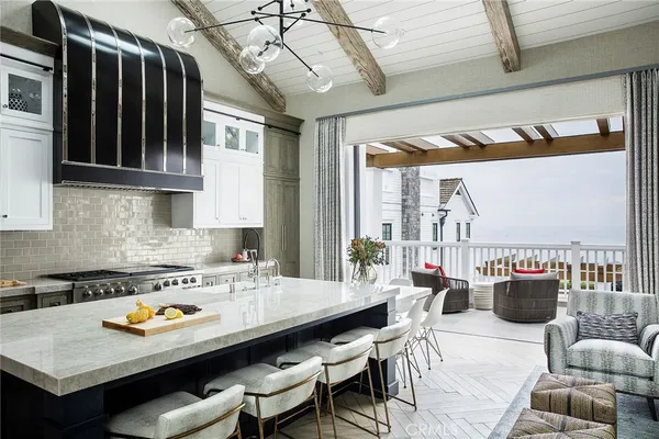 a kitchen with stainless steel appliances granite countertop a stove a sink dishwasher and cabinets with wooden floor