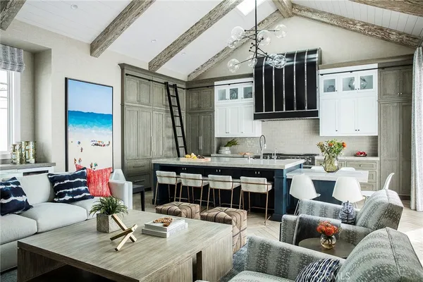 a living room with furniture kitchen view and a window