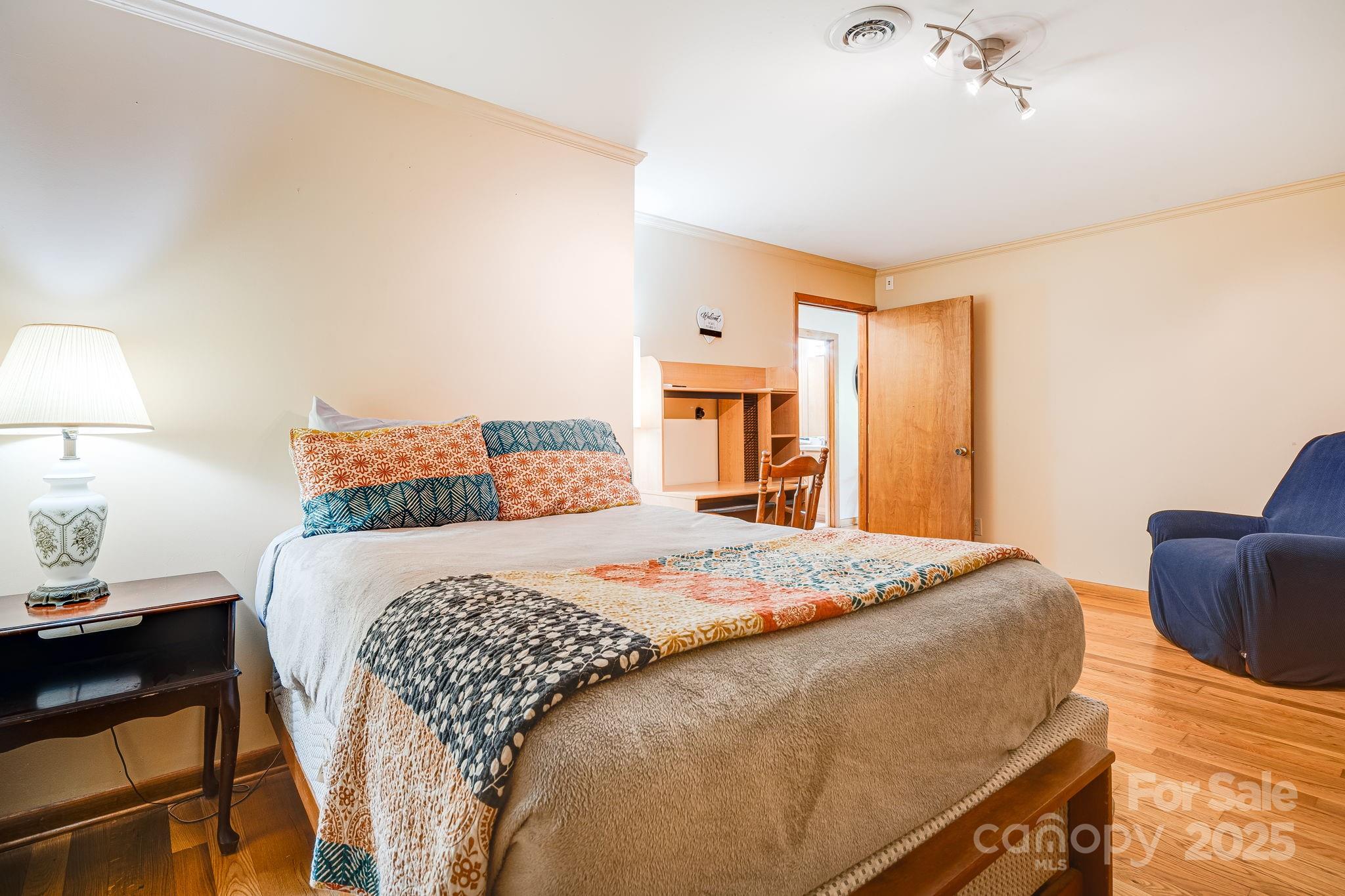 620 Mason Branch Road Bryson City, NC 28713 - Photo 22 of 43 a bedroom with a bed and wooden floor