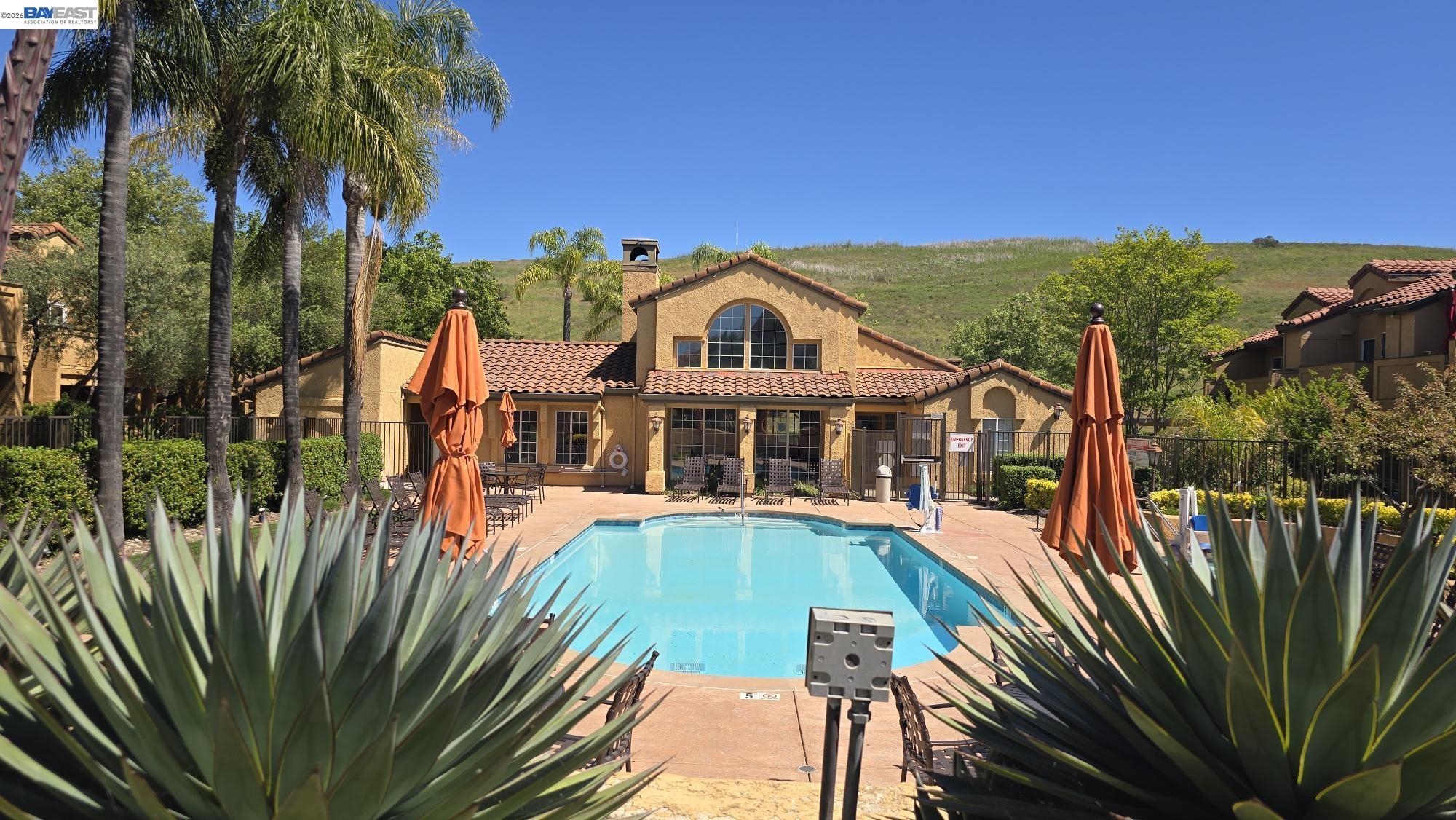 735 Watson Canyon Court, Unit 218 San Ramon, CA 94582 - Photo 20 of 26 a view of a house with a small yard and large trees