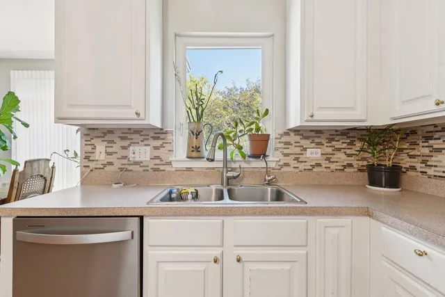 a kitchen with sink and cabinets