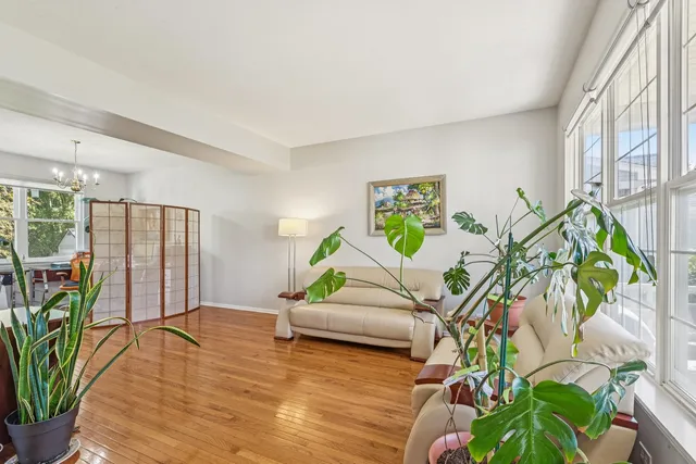 a living room with furniture windows and wooden floor