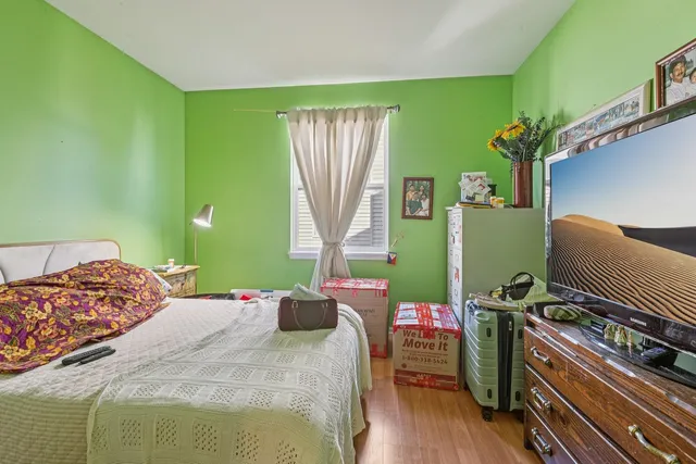 a bedroom with a bed and windows