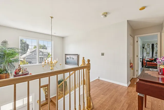 a view of a room with window & wooden floor