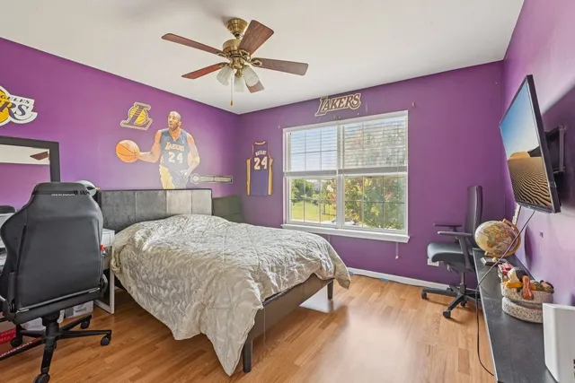 a bed room with a bed mirror and a window