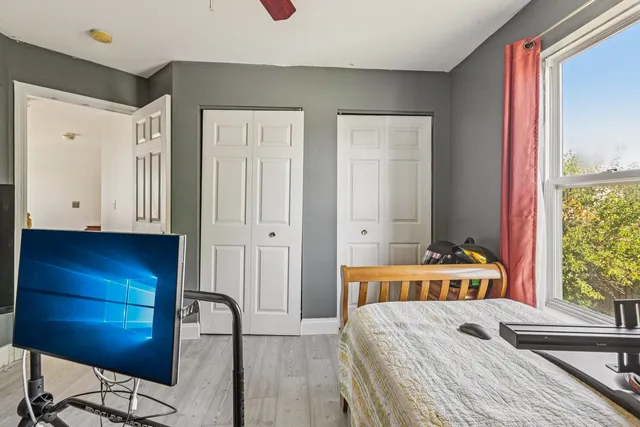 a bed room with a bed and a chair