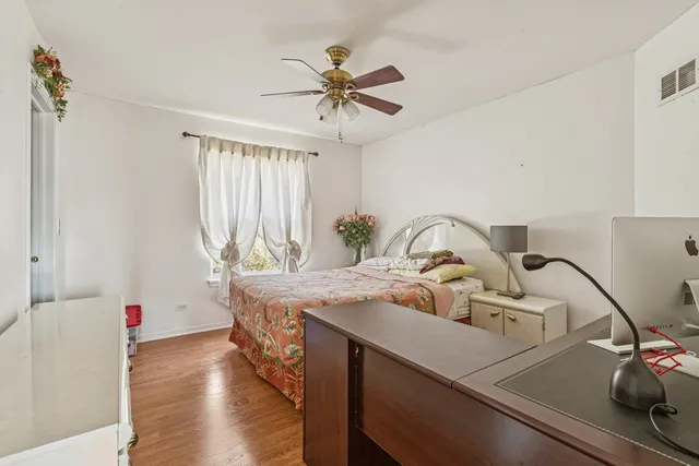 a view of dining room and kitchen with a sink wooden floor and chandelier