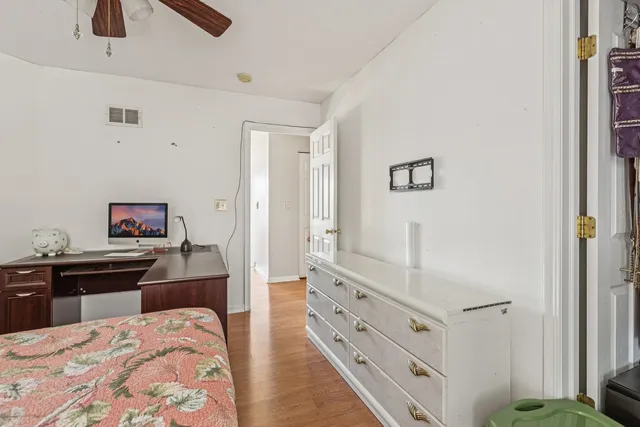 a bedroom with a bed and a dresser