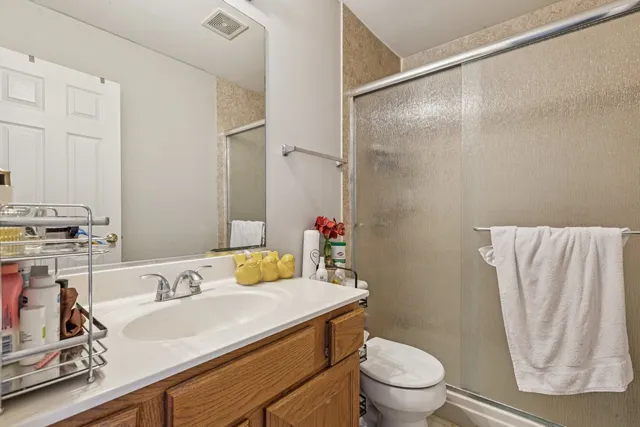 a bathroom with a sink toilet and shower