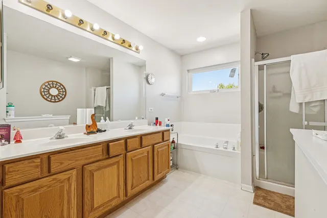 a bathroom with a tub sink and mirror